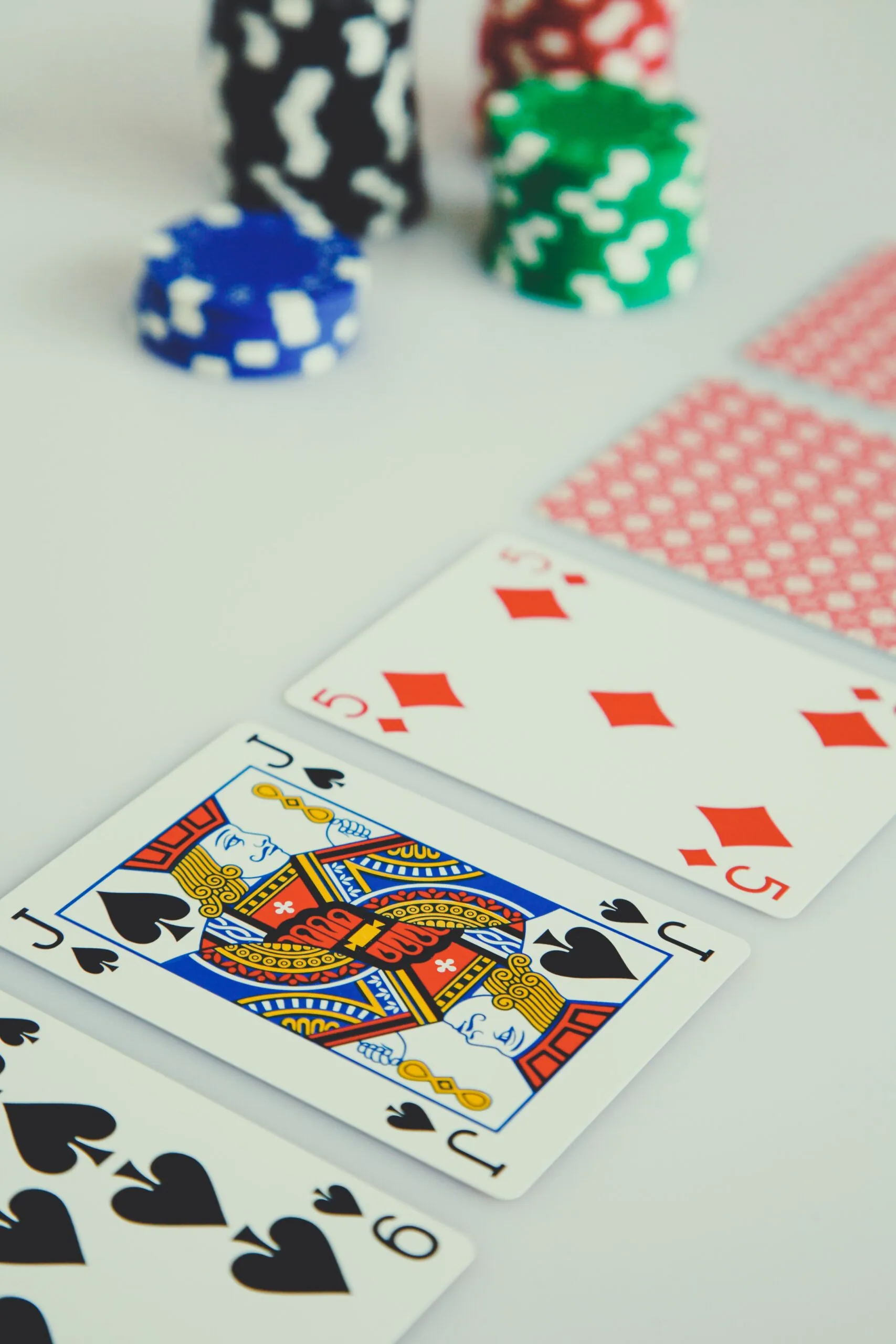 playing cards and poker chips sitting on a table
